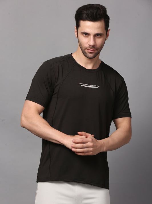 This image features a sleek, men's round neck black T-shirt. The T-shirt is designed with a minimalist approach, showcasing a small, white graphic on the upper left chest area.